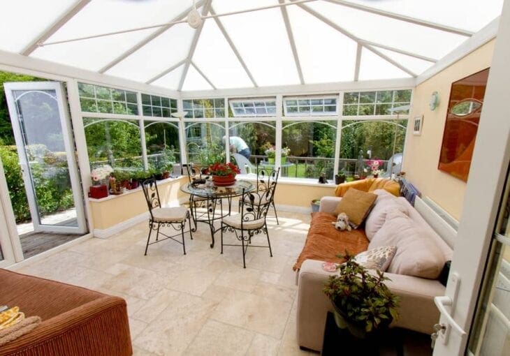 Bright traditional conservatory with white roof panels and large windows, ideal for conservatory blinds installation.